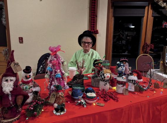 Photo credit Silverton Creative District Deborah Runion looking festive at her table for the Mistletoe Market.